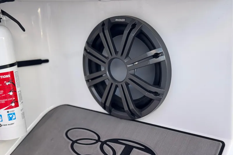 Slide: The Image of Speaker and fire extinguisher in 2024 Tahoe T21 boat interior. - 22
