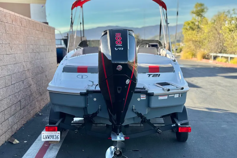 Slide: The Image of 2024 Tahoe T21 boat with V8 engine, parked outdoors, rear view. - 4