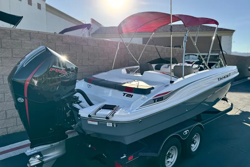 Slide: The Image of 2024 Tahoe T21 boat with Mercury Pro XS engine, parked outdoors under sunlight. - 5