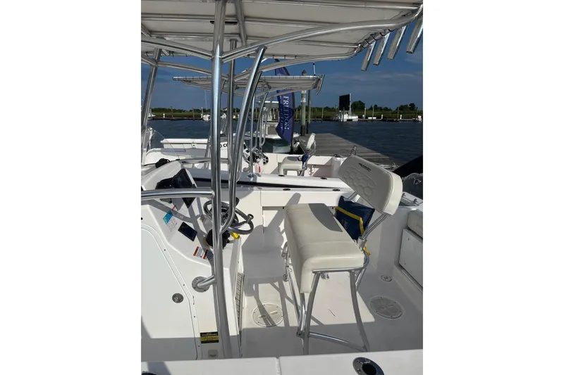 Slide: The Image of 2024 Aquasport 2200 Center Console boat interior with seating and controls. - 3
