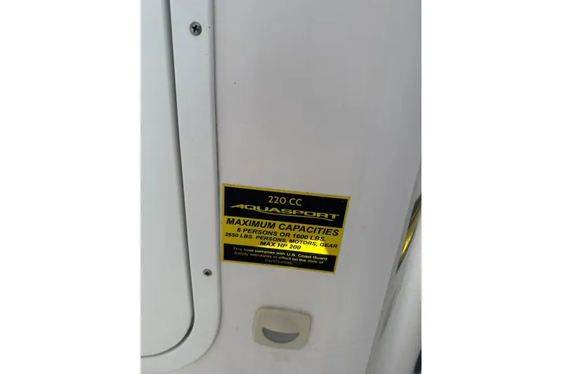 Slide: The Image of 2024 Aquasport 2200 Center Console capacity label, detailing maximum weight and passenger limits. - 9