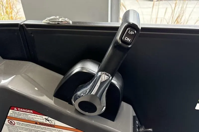 Slide: The Image of Close-up of 2026 Evotti 523CS control lever with "UP" and "DN" buttons. - 17