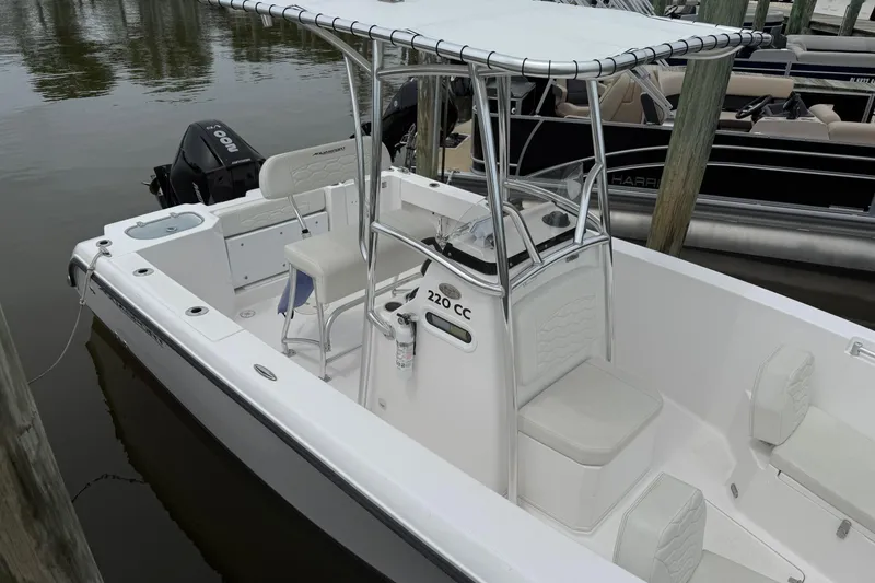 Slide: The Image of 2024 Aquasport 2200 Center Console boat docked, featuring sleek design and spacious seating. - 3