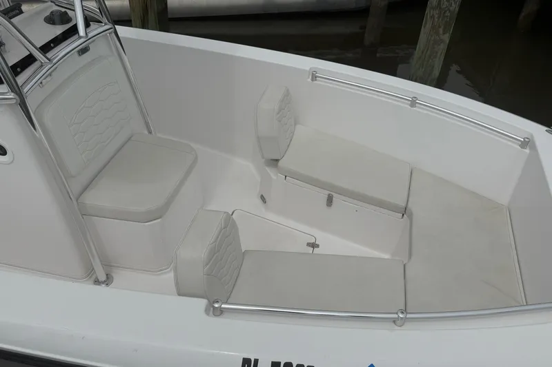 Slide: The Image of 2024 Aquasport 2200 Center Console boat interior with cushioned seating and sleek design. - 4