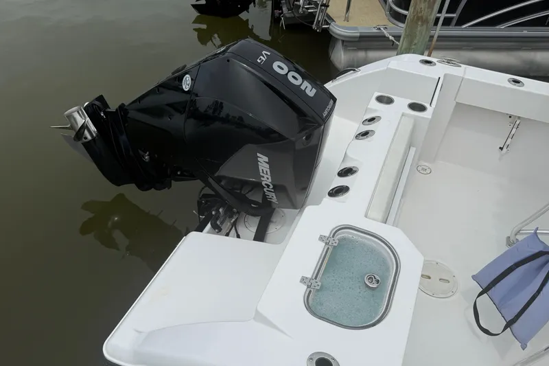 Slide: The Image of 2024 Aquasport 2200 Center Console with Mercury outboard engine, docked at marina. - 6