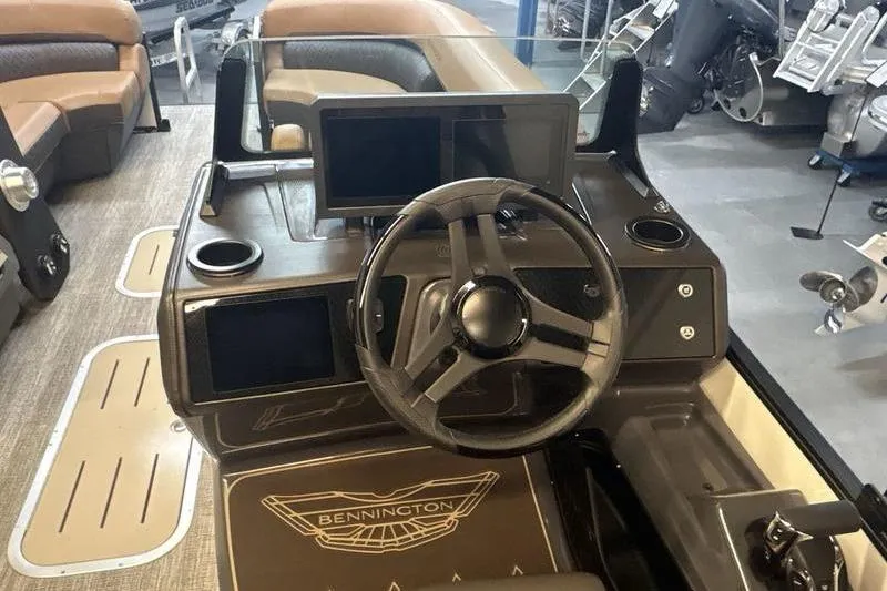 Slide: The Image of 2026 Bennington 24 MSL boat dashboard with steering wheel and digital displays. - 11
