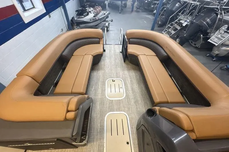 Slide: The Image of 2026 Bennington 24 MSL pontoon boat interior with tan seating and spacious layout. - 13
