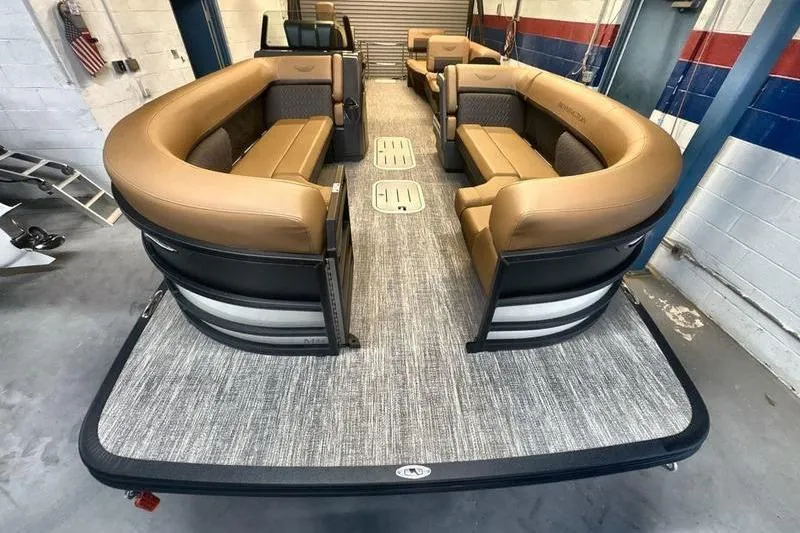Slide: The Image of 2026 Bennington 24 MSL pontoon boat interior with tan seating and gray flooring. - 14