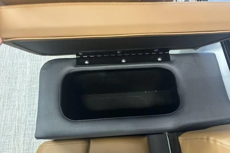 Slide: The Image of Open storage compartment in 2026 Bennington 24 MSL boat with tan upholstery. - 18