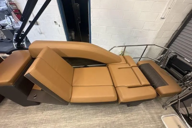 Slide: The Image of 2026 Bennington 24 MSL boat interior with luxurious tan seating and adjustable lounge. - 3