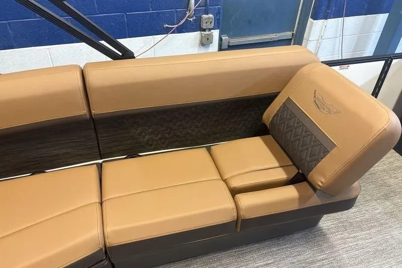 Slide: The Image of 2026 Bennington 24 MSL boat seating with tan and brown upholstery in a showroom. - 7