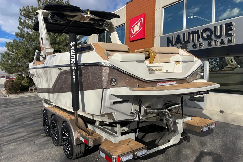 Slide: The Image of 2026 Nautique Super Air Nautique G25 Paragon boat at dealership, rear view. - 3