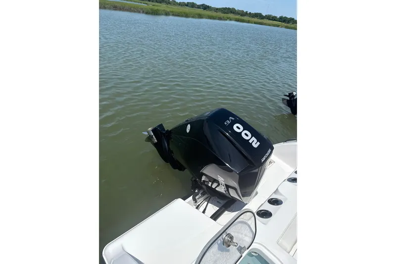 Slide: The Image of 2024 Aquasport 2200 Center Console boat with 200 HP outboard motor on water. - 10