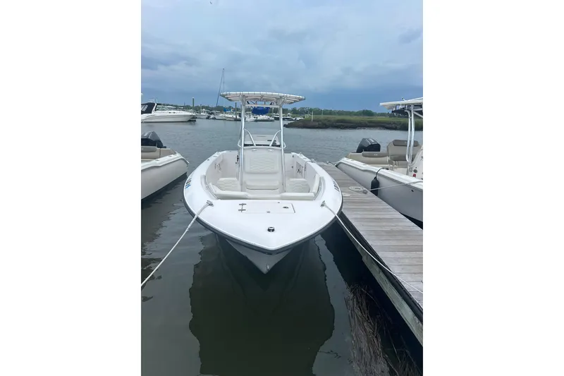 Slide: The Image of 2024 Aquasport 2200 Center Console boat docked at marina, front view. - 4