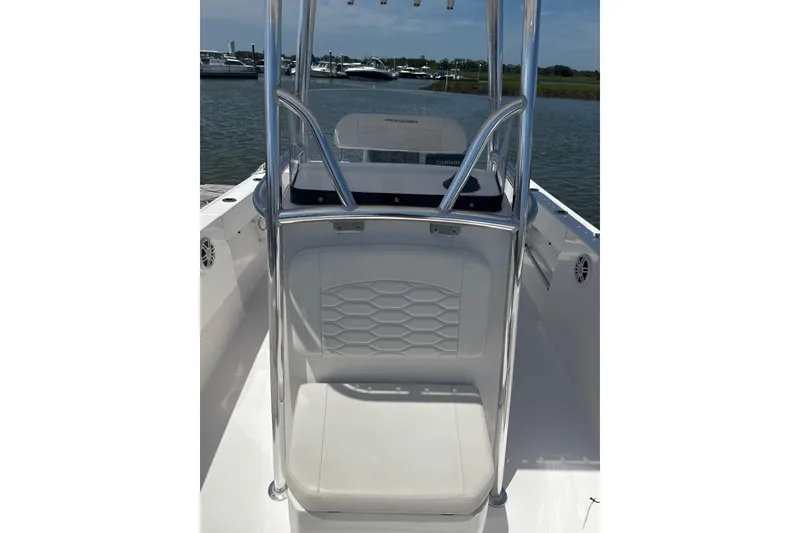 Slide: The Image of 2024 Aquasport 2200 Center Console boat interior with seating and console view. - 8