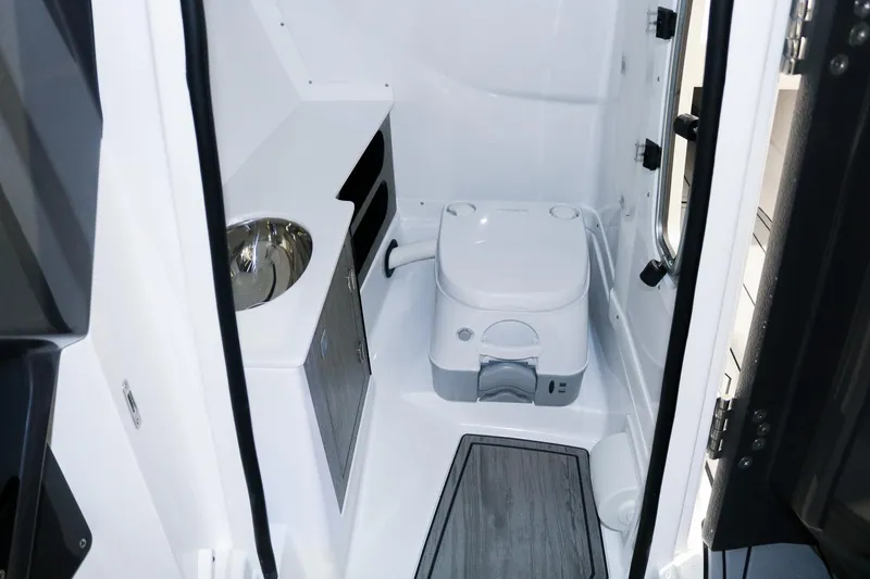 Slide: The Image of 2025 Monterey 278 Super Sport boat interior with compact bathroom amenities. - 12