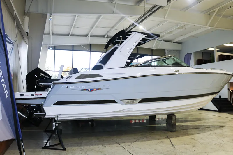 Slide: The Image of 2025 Monterey 278 Super Sport boat displayed in a showroom. - 2