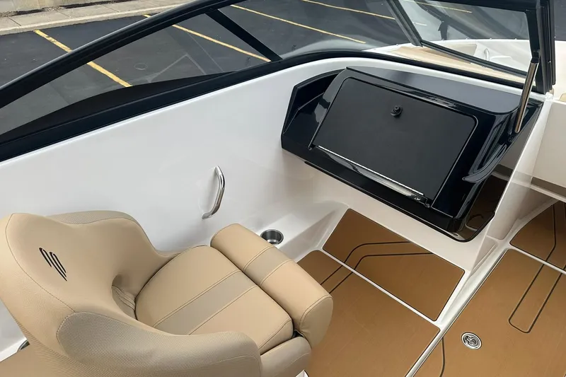 Slide: The Image of 2026 Bayliner V20 boat interior with beige seating and sleek dashboard design. - 10