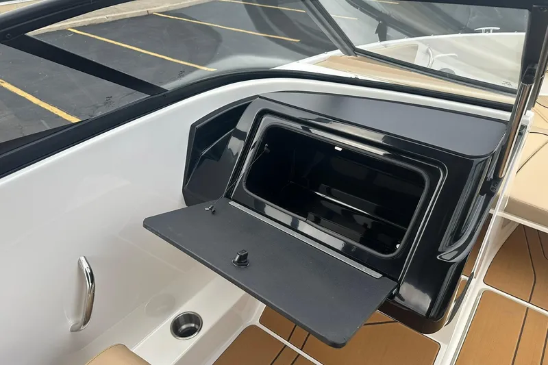 Slide: The Image of 2026 Bayliner V20 boat interior with open storage compartment and sleek design. - 11