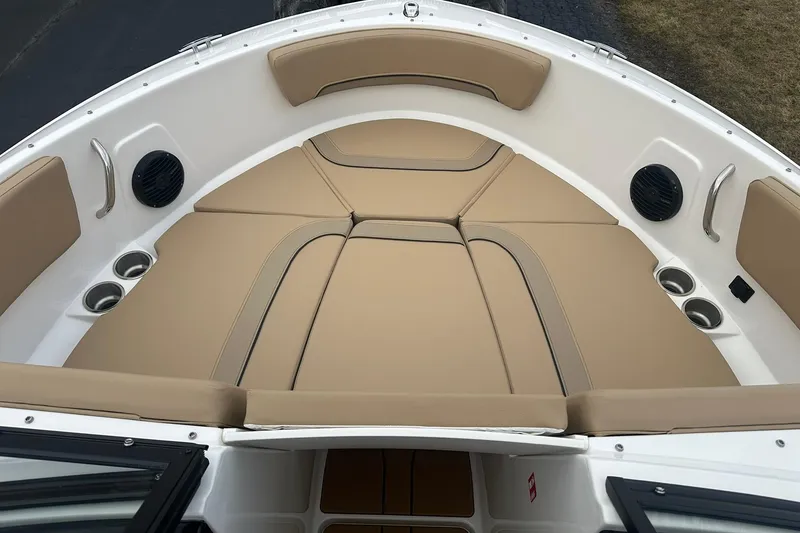Slide: The Image of 2026 Bayliner V20 boat interior with tan cushioned seating and cup holders. - 12
