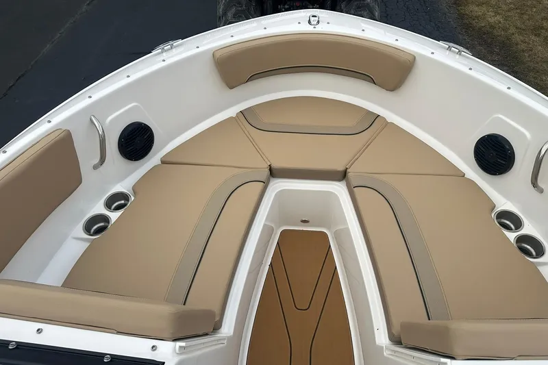 Slide: The Image of 2026 Bayliner V20 boat interior with beige seating and cup holders. - 13