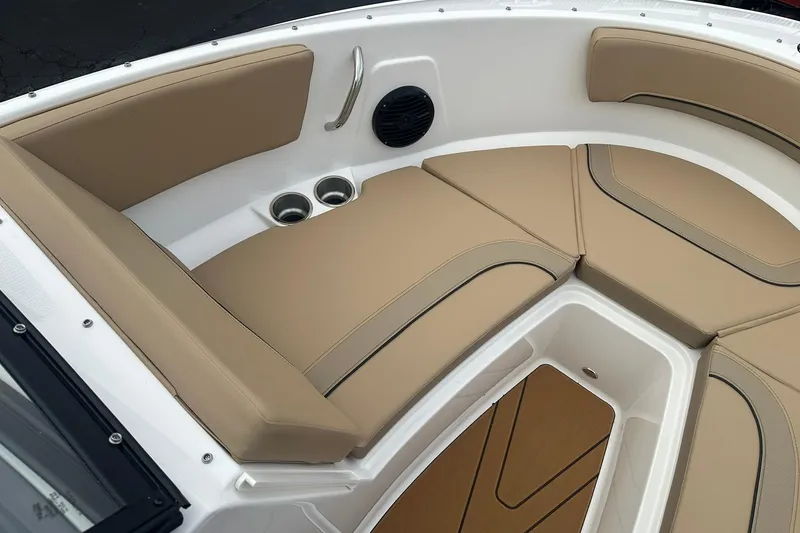 Slide: The Image of 2026 Bayliner V20 boat interior with tan cushioned seating and cup holders. - 14