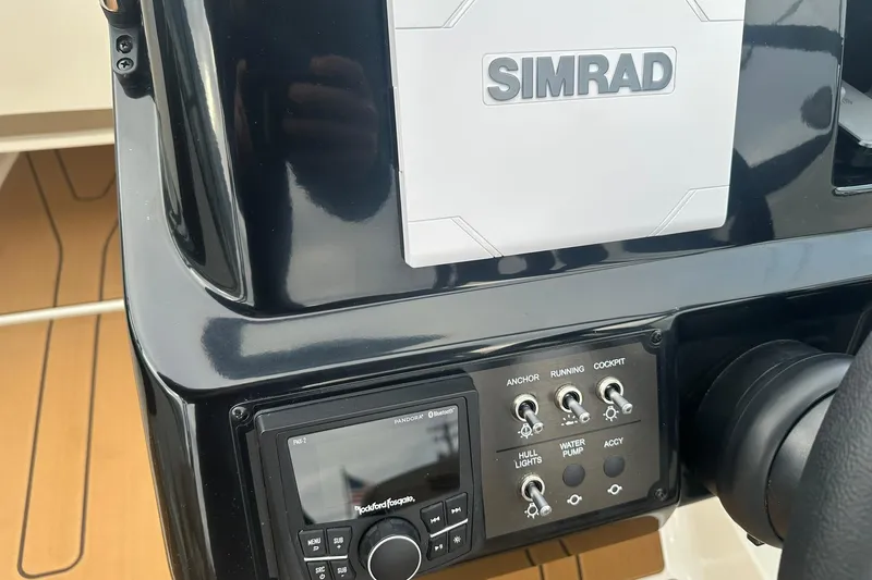 Slide: The Image of Control panel of 2026 Bayliner V20 boat with Simrad system and switches. - 18
