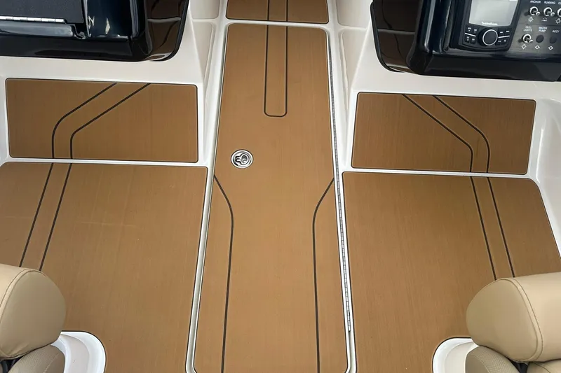 Slide: The Image of 2026 Bayliner V20 boat interior with sleek brown flooring and modern dashboard. - 20