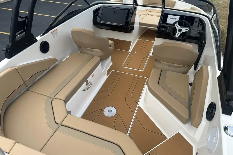 Slide: The Image of 2026 Bayliner V20 boat interior with tan seating and modern dashboard. - 5