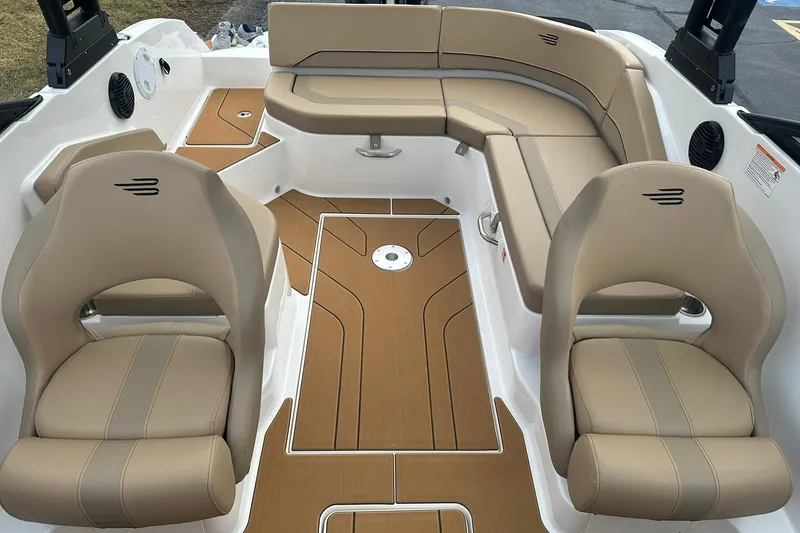Slide: The Image of 2026 Bayliner V20 boat interior with beige seating and wood-style flooring. - 7