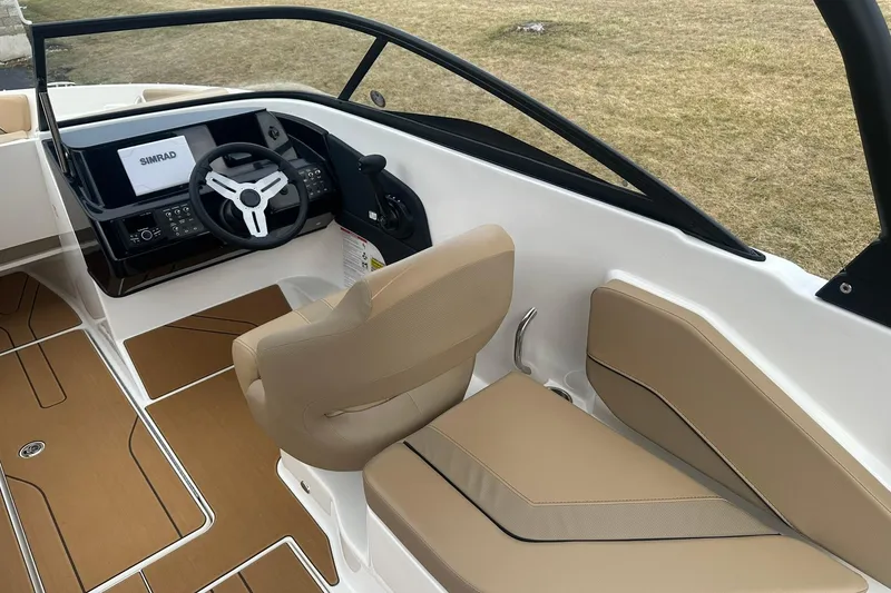 Slide: The Image of 2026 Bayliner V20 boat interior with modern dashboard and beige seating. - 8
