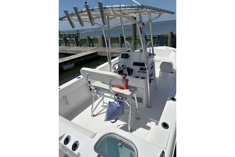 Slide: The Image of 2024 Aquasport 2200 Center Console boat docked, featuring sleek design and modern controls. - 6