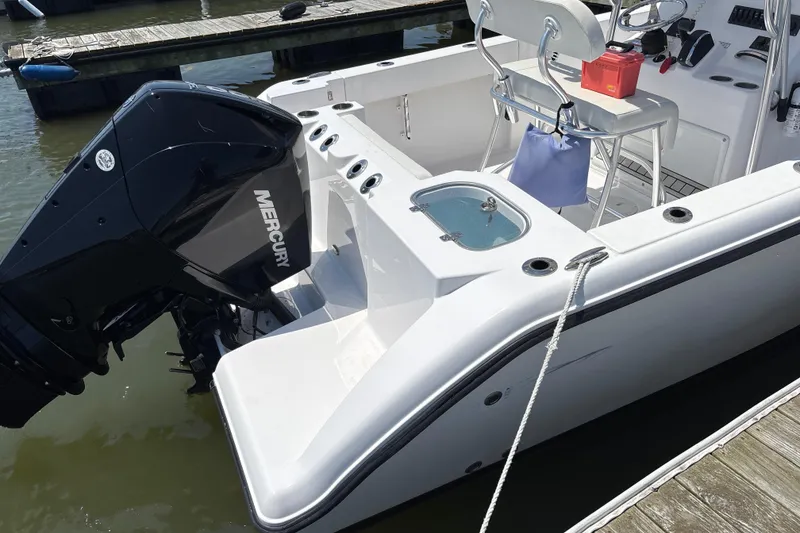 Slide: The Image of 2024 Aquasport 2200 Center Console boat with Mercury engine docked at marina. - 7