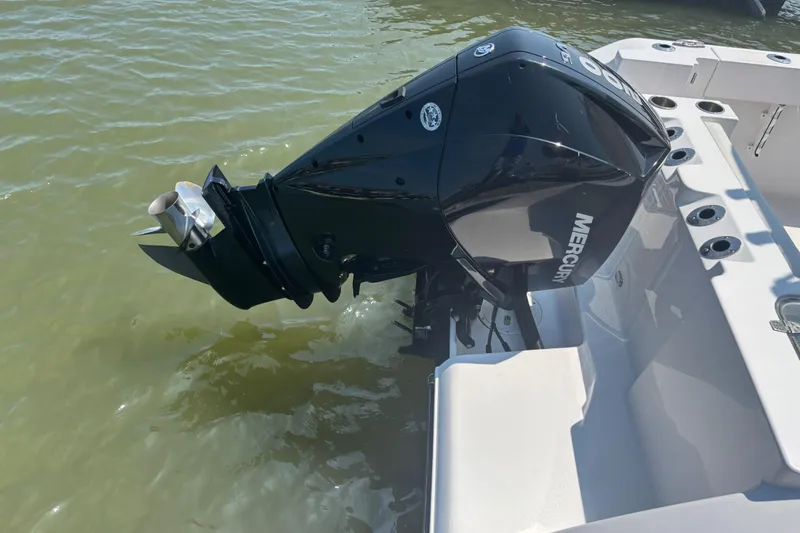 Slide: The Image of 2024 Aquasport 2200 Center Console with Mercury outboard engine in water. - 8