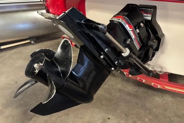 Slide: The Image of 1995 Crownline 180 BR boat engine and propeller in a garage setting. - 10