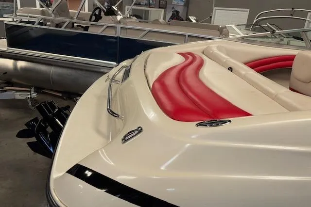 Slide: The Image of 1995 Crownline 180 BR boat with red and white interior, displayed indoors. - 13