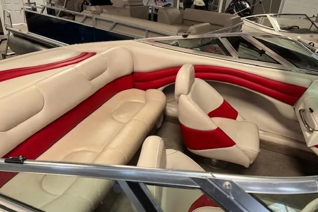 Slide: The Image of 1995 Crownline 180 BR boat interior with red and cream seating, showcasing stylish design. - 14