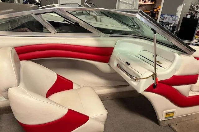 Slide: The Image of 1995 Crownline 180 BR boat interior with red and white seating and dashboard. - 16