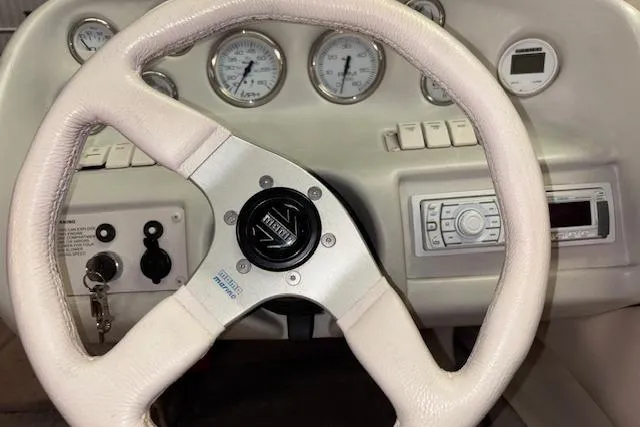 Slide: The Image of 1995 Crownline 180 BR dashboard with steering wheel and gauges. - 17