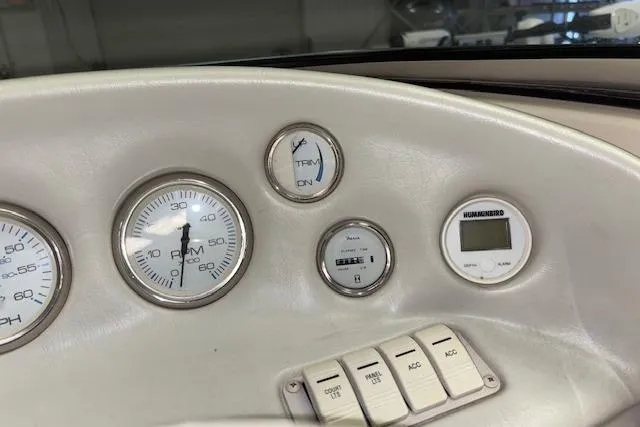 Slide: The Image of Dashboard of a 1995 Crownline 180 BR boat with gauges and switches. - 19