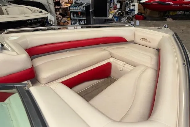 Slide: The Image of Interior of a 1995 Crownline 180 BR boat with beige and red seating. - 20
