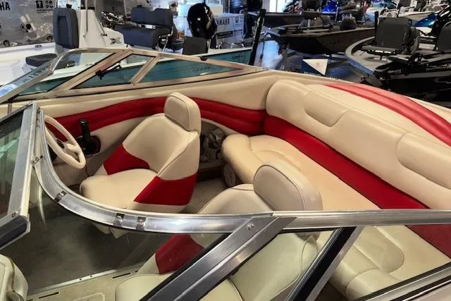 Slide: The Image of Interior of a 1995 Crownline 180 BR boat with red and beige seating. - 21