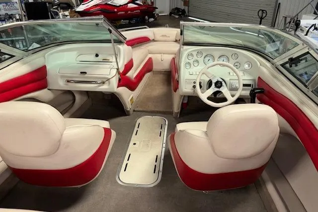 Slide: The Image of 1995 Crownline 180 BR boat interior with red and white seating and dashboard. - 22