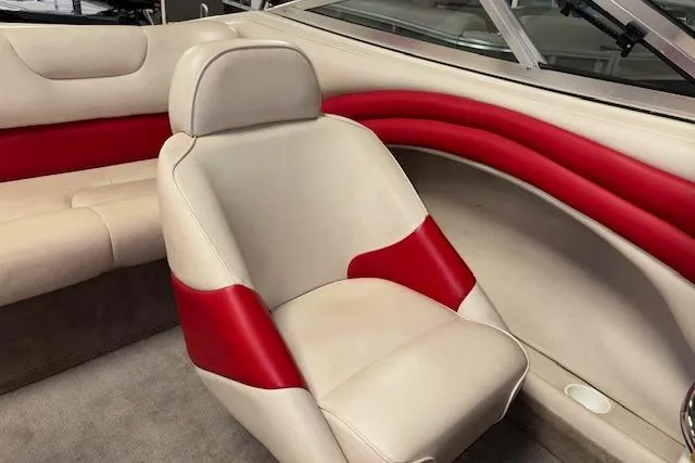 Slide: The Image of 1995 Crownline 180 BR boat interior with beige and red seating. - 25