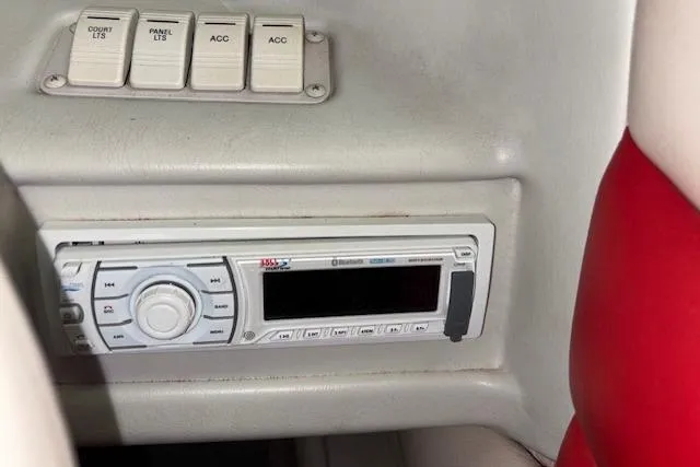 Slide: The Image of 1995 Crownline 180 BR boat dashboard with stereo and control switches. - 26