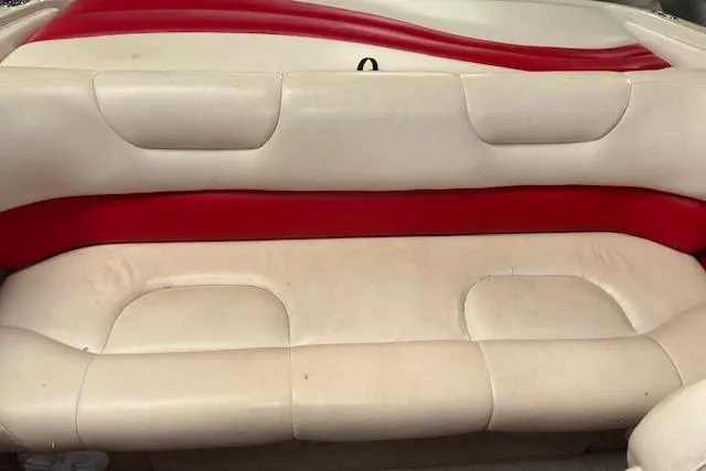 Slide: The Image of 1995 Crownline 180 BR boat interior with beige and red seating. - 30