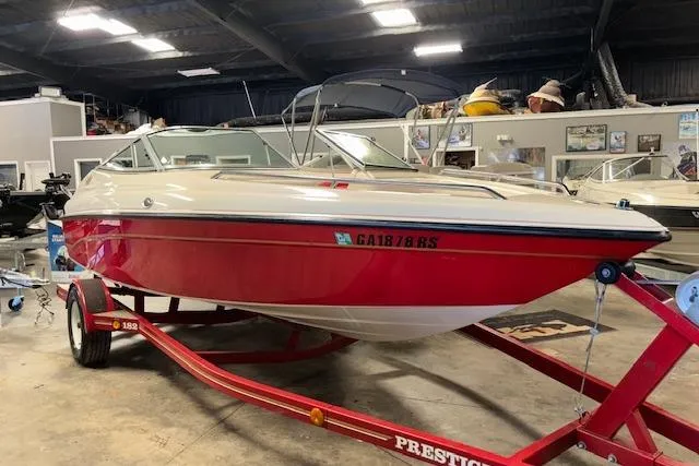 Slide: The Image of 1995 Crownline 180 BR boat on red trailer in indoor storage facility. - 4