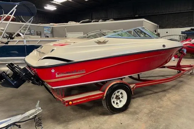 Slide: The Image of 1995 Crownline 180 BR boat in a garage, red and white design on trailer. - 5