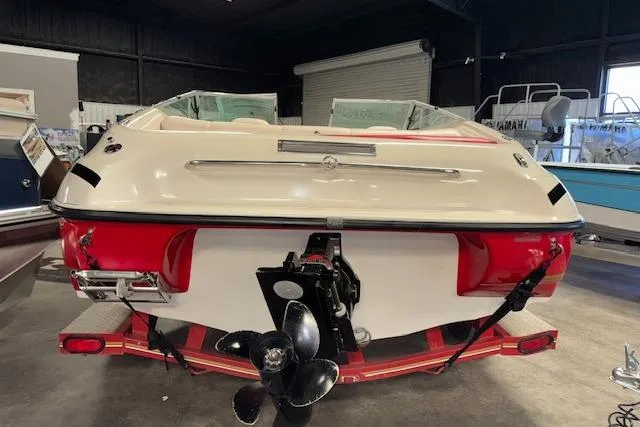 Slide: The Image of 1995 Crownline 180 BR boat in a showroom, rear view with propeller visible. - 6
