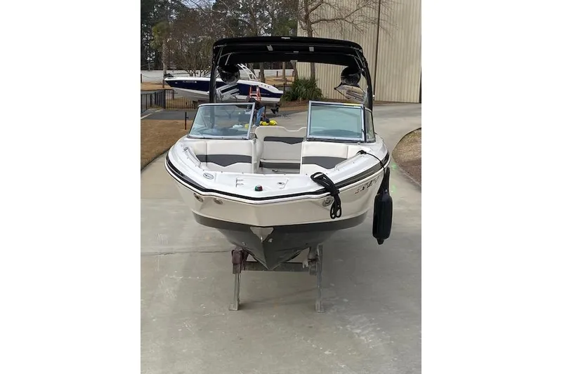 Slide: The Image of 2013 Chaparral 226 SSi boat on a stand, front view, outdoors. - 4